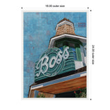 Framed canvas print with a teal vintage neon sign reading 'Not the Boss of Me' atop a green and white building turret, set against a blue map background.