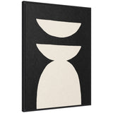Framed abstract canvas with a black background featuring three white geometric shapes: a semicircle, an inverted semicircle, and a rounded arch stacked vertically.