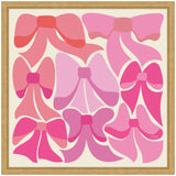 Nine stylized bows in varying shades of pink and red, arranged in three rows within a simple wooden frame on a light background.
