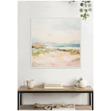 Soft pastel-toned landscape painting with pale pink foreground, green grassy middle, and muted blue-gray sky, framed and hung above a wood and metal console table.