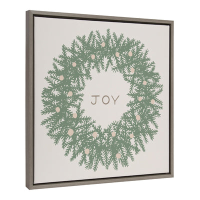Sylvie Joy Wreath Green Framed Canvas by Hannah Beisang showing a green wreath with the word 'Joy' inside on a gray polystyrene frame