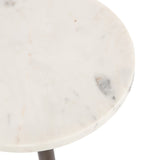 Close-up of a circular white marble table top with subtle gray and beige veining, showing smooth polished edges and surface texture.