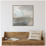 Square abstract canvas with soft grays, blues, and beige brushstrokes and scribbles hanging above a wooden bench with a beige pillow reading 'welcome home'