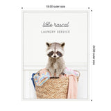 Illustration of a raccoon sitting inside a woven laundry basket filled with colorful clothes, labeled 'little rascal laundry service' in gray text above.