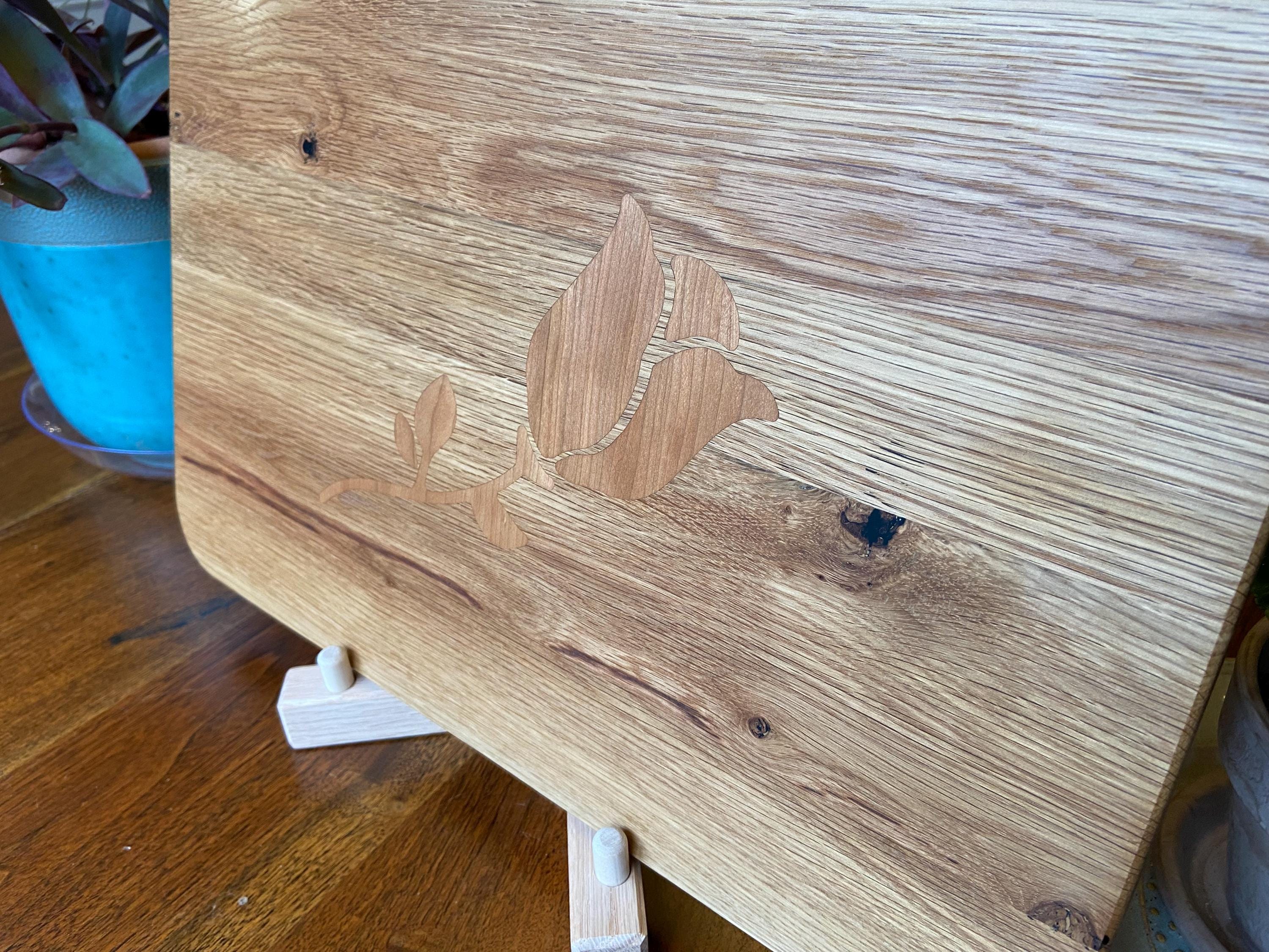 White Oak charcuterie board with subtle Cherry rose and stem inlay, handcrafted by Fitzgerald Custom Woodcraft