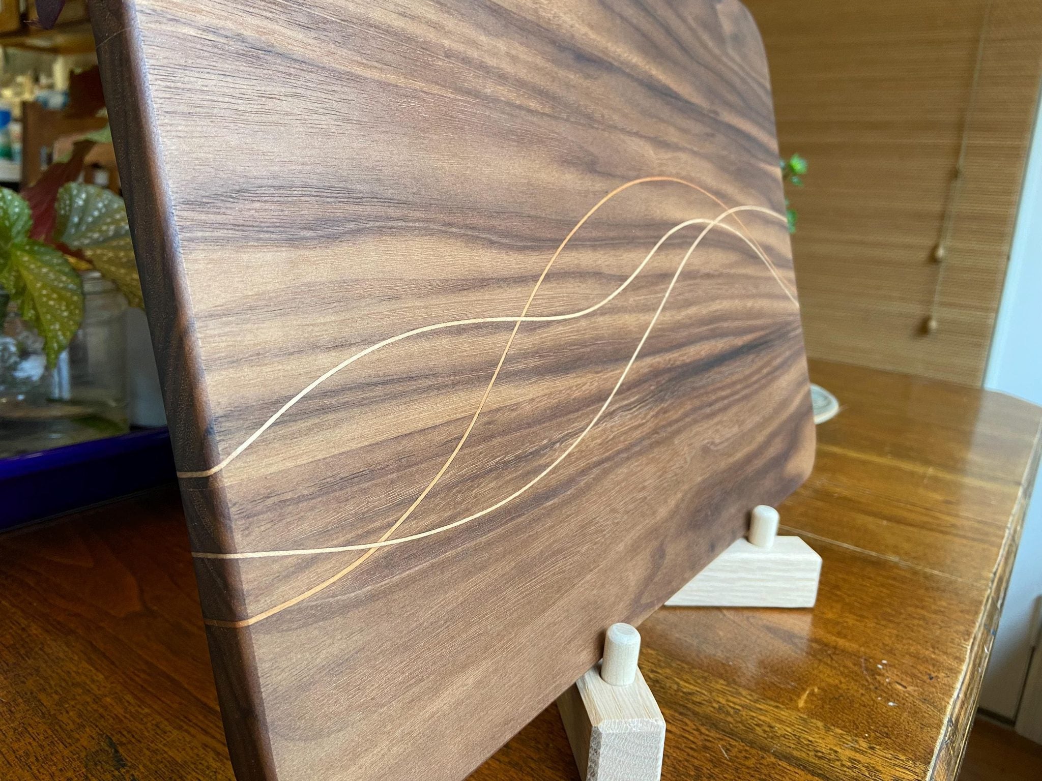 Walnut charcuterie board with cherry and maple decorative banding by Fitzgerald Custom Woodcraft