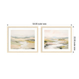 Two framed landscape prints side by side, each depicting soft, muted hills and water in beige, green, and pale pink tones, with light wooden frames and white mats.