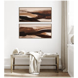 Two rectangular horizontal abstract canvas art pieces with layered brown, beige, and black brushstrokes, hung one above the other on a white wall above a wooden bench.
