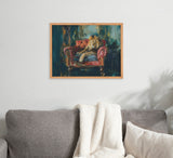 Framed painting of a lion lounging on a deep red armchair against a dark, textured background, hanging above a gray sofa with a white blanket and pillow.