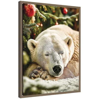 Framed canvas art showing a polar bear sleeping beneath a decorated Christmas tree with ornaments on snow-covered ground.