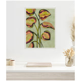 Framed canvas painting of heart-shaped green leaves with red and purple accents on slender stems against a muted green background, displayed on a white wall.