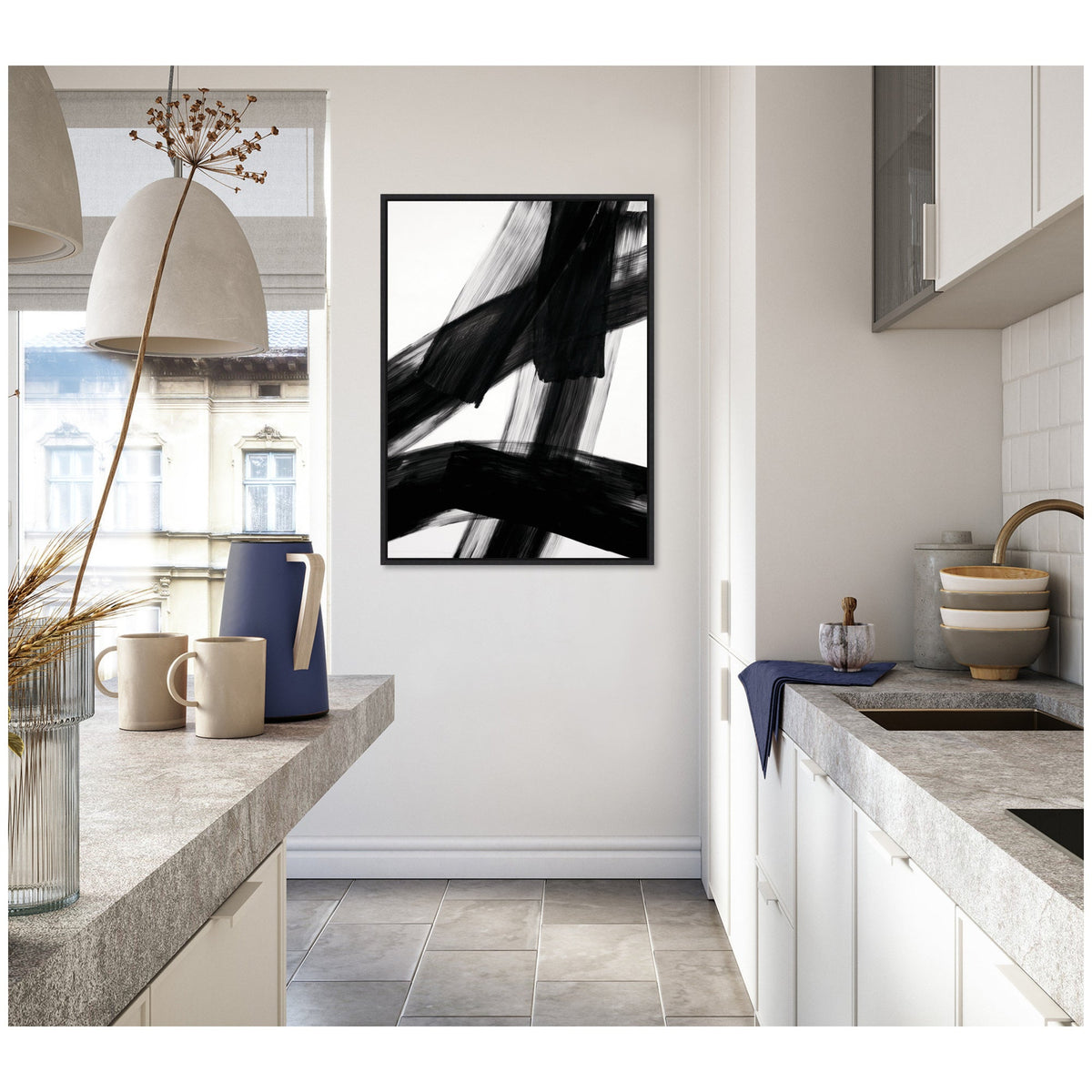 Minimalist kitchen with concrete countertops and white cabinets featuring a framed abstract black brushstroke art on the white wall.