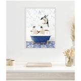 Blue clawfoot bathtub with two penguins inside and one jumping in, set against a white wall with blue floral wallpaper and blue patterned floor tiles.