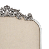 Top left corner of a beige fabric pinboard framed in silver with ornate, vintage-style acanthus leaf and scroll detailing.