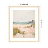 Soft pastel landscape painting featuring a sandy beach with greenish dune grasses and distant blue-gray cliffs under a pale sky, framed in light wood with white matting.
