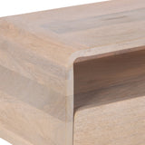 Close-up of a light wood side table corner with a smooth, rounded edge and an open rectangular storage compartment beneath the tabletop.