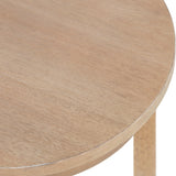 Close-up of a round wooden side table with a smooth, light natural finish and slender legs visible beneath the tabletop edge.