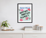 Framed canvas of a guest check paper with handwritten text 'ANOTHER MARTINI PLEASE!!' surrounded by red lipstick marks and black hearts, hanging on a white wall above a white dresser.