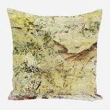 Soft pillow with an abstract design in pale yellow, beige, and hints of brown and black, featuring textured, brushstroke-like patterns.