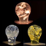 Three handcrafted flower-shaped resin LED bulbs in a 3-pack
