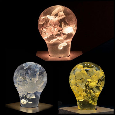 Three handcrafted flower-shaped resin LED bulbs in a 3-pack
