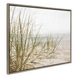 Framed canvas showing tall beach grass with thin green and brown blades on sandy dunes against a pale, misty sky and calm ocean background.