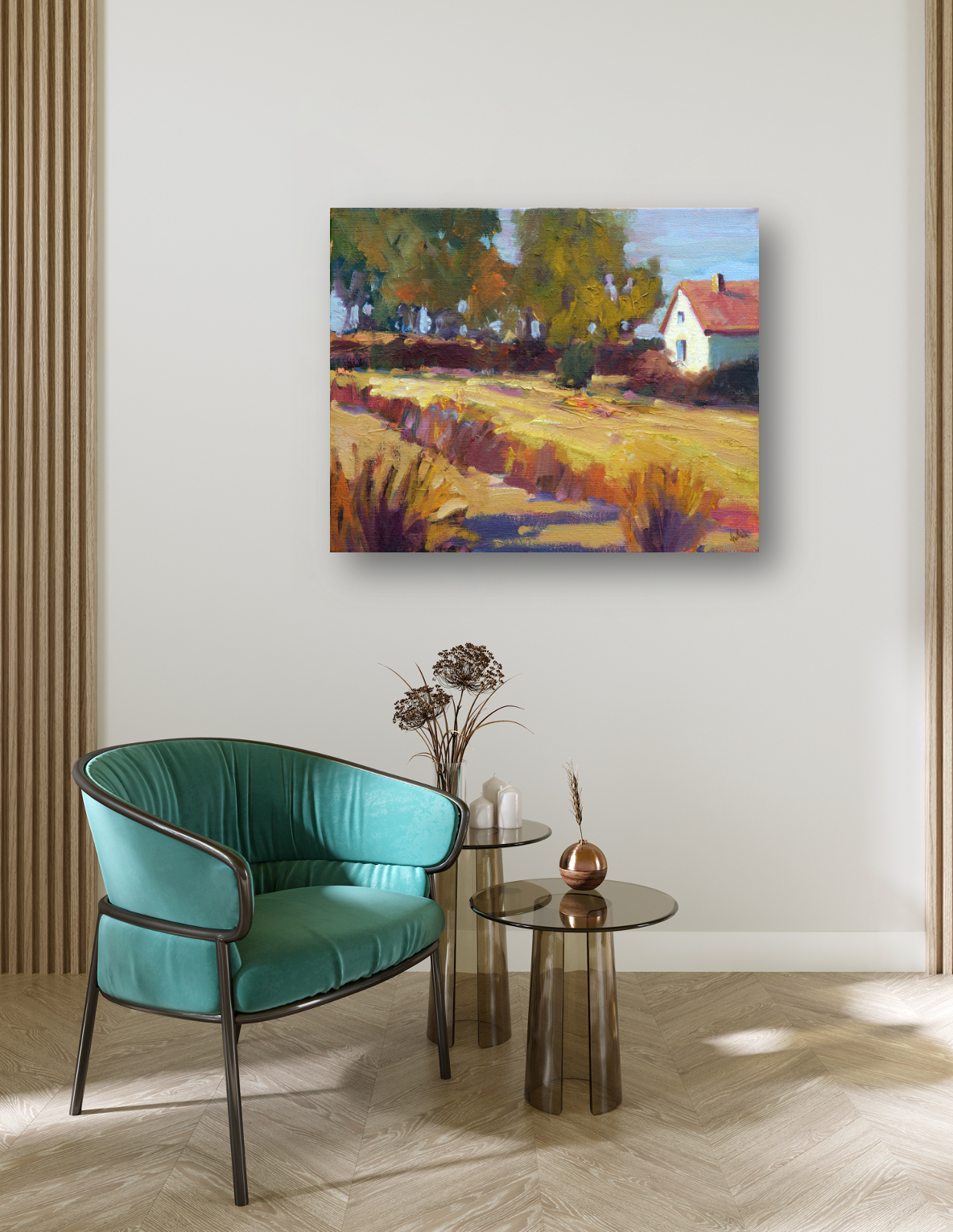 Impressionist canvas painting of an autumn rural scene with golden fields, colorful trees, and a white house with a red roof under a blue sky, hanging above a teal chair.