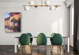 Dining room with a modern rectangular table, six green upholstered chairs with gold legs, a brass chandelier with six white globe lights, and an impressionistic painting on a white wall.