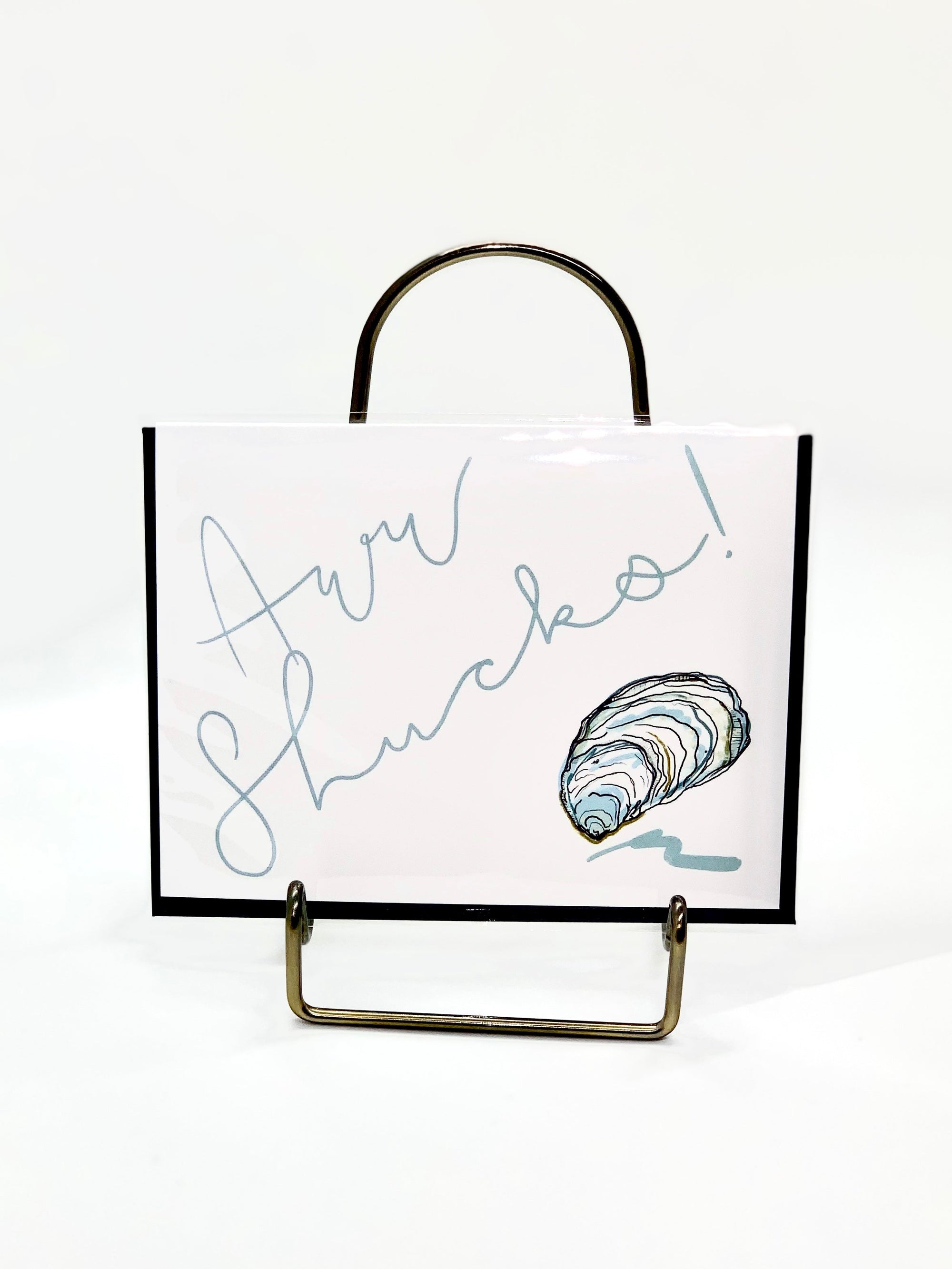 Aww Shucks Greeting Card showing an illustrated coastal shell design on the front with blank interior
