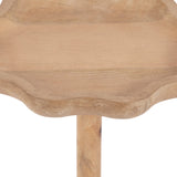 Close-up of a scalloped-edge wooden table top with natural wood grain, showing part of a single supporting leg beneath it.