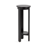 Tall, round black wood side table with three vertical legs and a small circular shelf near the base.