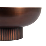 Close-up of a round metal bowl with a smooth, matte copper finish and a vertically ribbed cylindrical base in a darker copper tone.