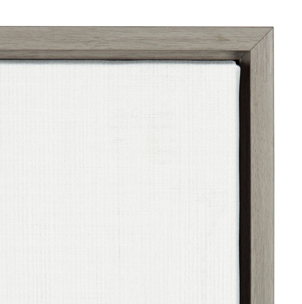 Close-up of white canvas texture in a simple, thin wooden frame with grayish-brown finish, showing canvas edges and corner joint of the frame.
