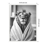 Black and white photo of a lion wrapped in a soft towel, sitting calmly with a blurred bathroom background.