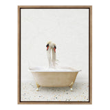 Two white swans with curved necks facing each other in a vintage beige clawfoot bathtub on a terrazzo-patterned floor against a light textured wall.