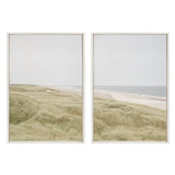 Framed canvas set featuring a soft coastal landscape with beige grassy dunes in foreground and calm grey sea under pale sky.