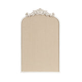 Arched pinboard with a textured beige surface and an ornate white carved decorative crest on the top center of the frame.