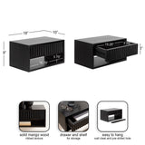 Rectangular black floating side table made of solid mango wood with ribbed drawer front, open lower shelf, wall cleat mount, and pre-drilled hole, shown closed and with drawer open.
