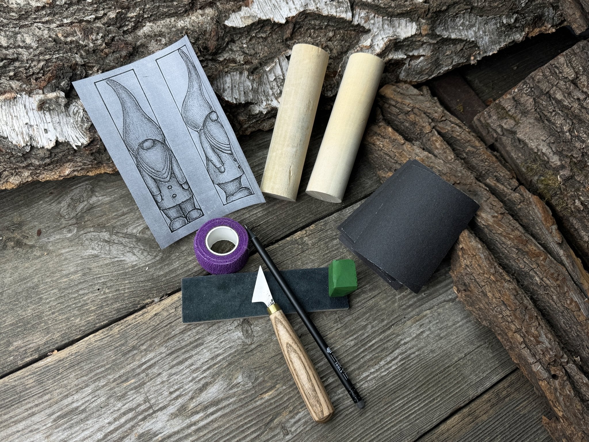 Gnome Carving Kit with carving knife, wooden blocks, sandpaper, sharpening board, pencil, and gnome drawing template