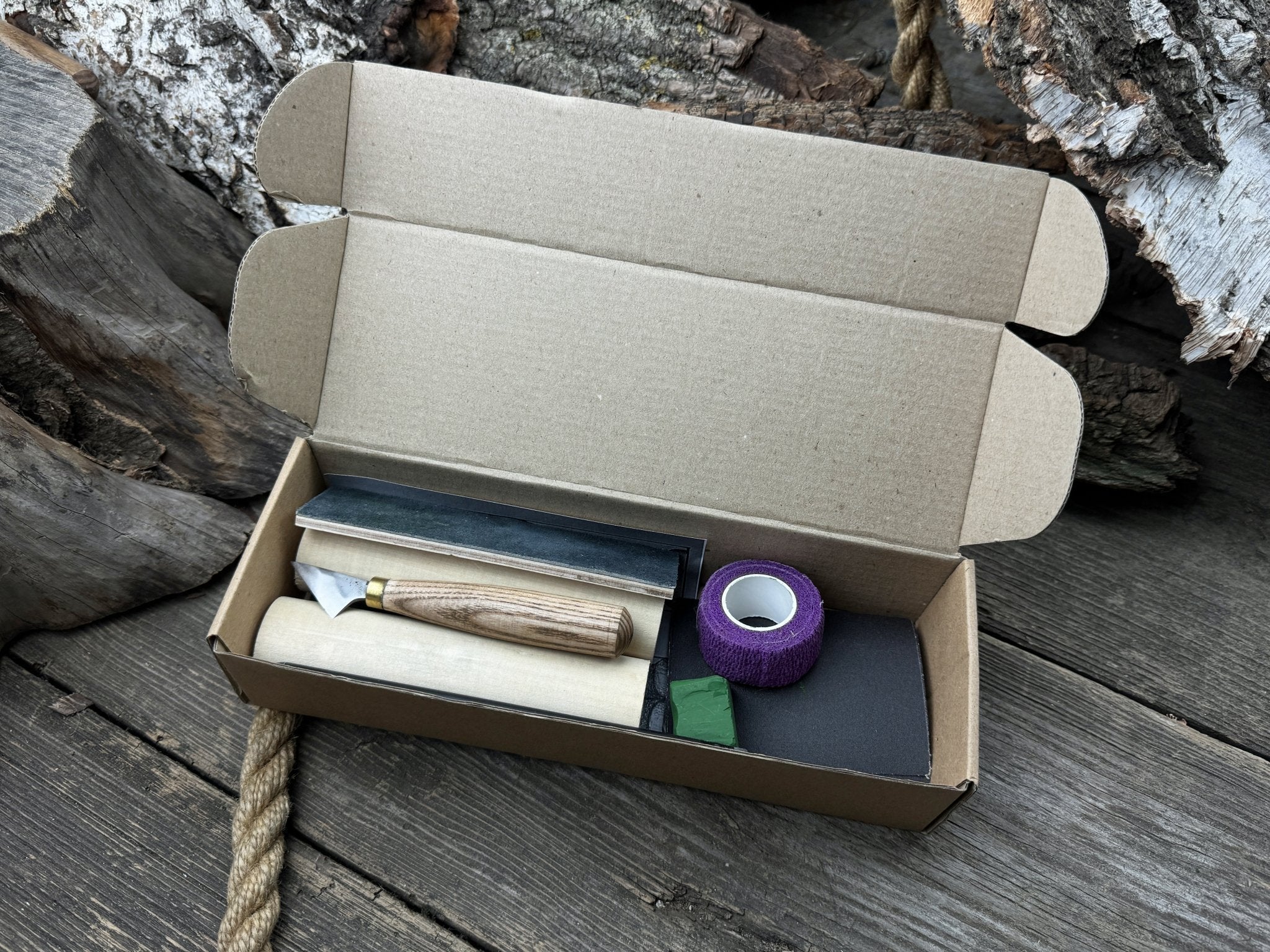 Gnome Carving Kit with carving knife, wooden blocks, sandpaper, sharpening board, pencil, and gnome drawing template