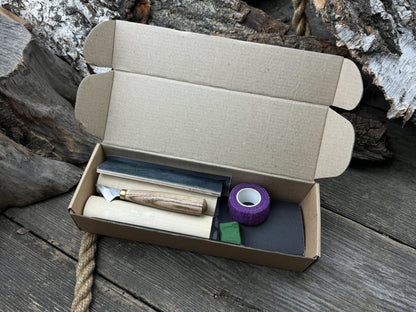 Gnome Carving Kit with carving knife, wooden blocks, sandpaper, sharpening board, pencil, and gnome drawing template