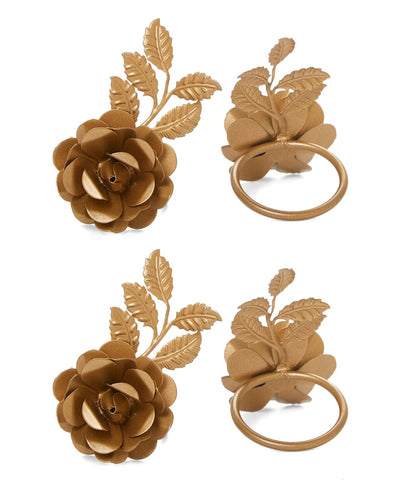Set of four Vibhsa Golden Rose napkin rings displayed on a white surface