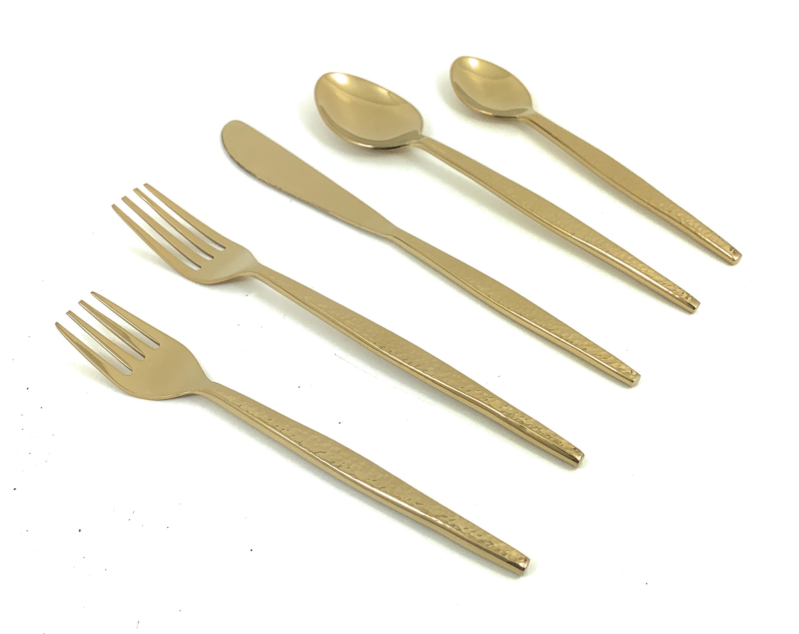 Vibhsa 20 Piece Gold Flatware Set with hammered texture laid out on table