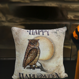 Square decorative throw pillow with a detailed owl perched in front of a large pale moon and the words 'Happy Halloween' on a cracked beige background.