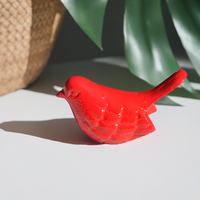 Red handcrafted aluminum bird figurine by Vibhsa displayed on a white surface