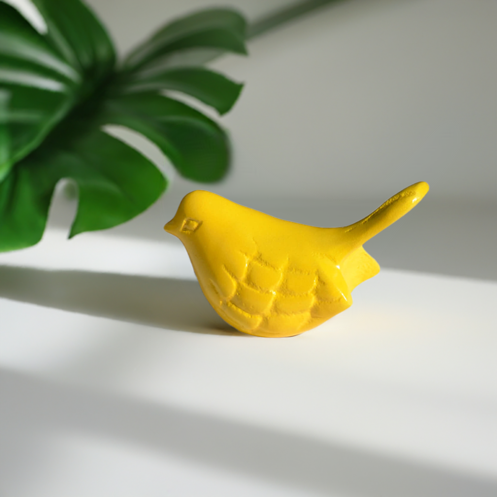Yellow Vibhsa bird figurine on white background