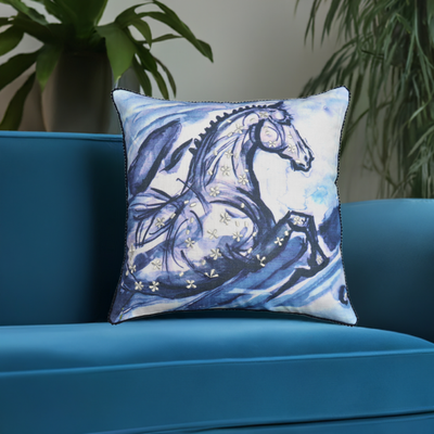 Embroidered blue decorative pillow with horse design, pom-poms, and tassels