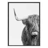 Black and white framed canvas print featuring a close-up of a Highland cow with long shaggy hair and one large horn, shown against a plain white background.