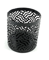 Black metal votive candle holder with an intricate abstract wavy cutout pattern, cylindrical shape, shown on white background.