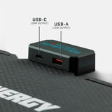 Black rectangular adapter with USB-C and USB-A ports labeled with 18W and 15W output, attached to a textured black surface with hexagonal pattern